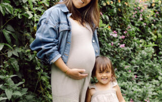 Dr. Renie Ikeda and her daughter smiling in a garden, expecting baby #2